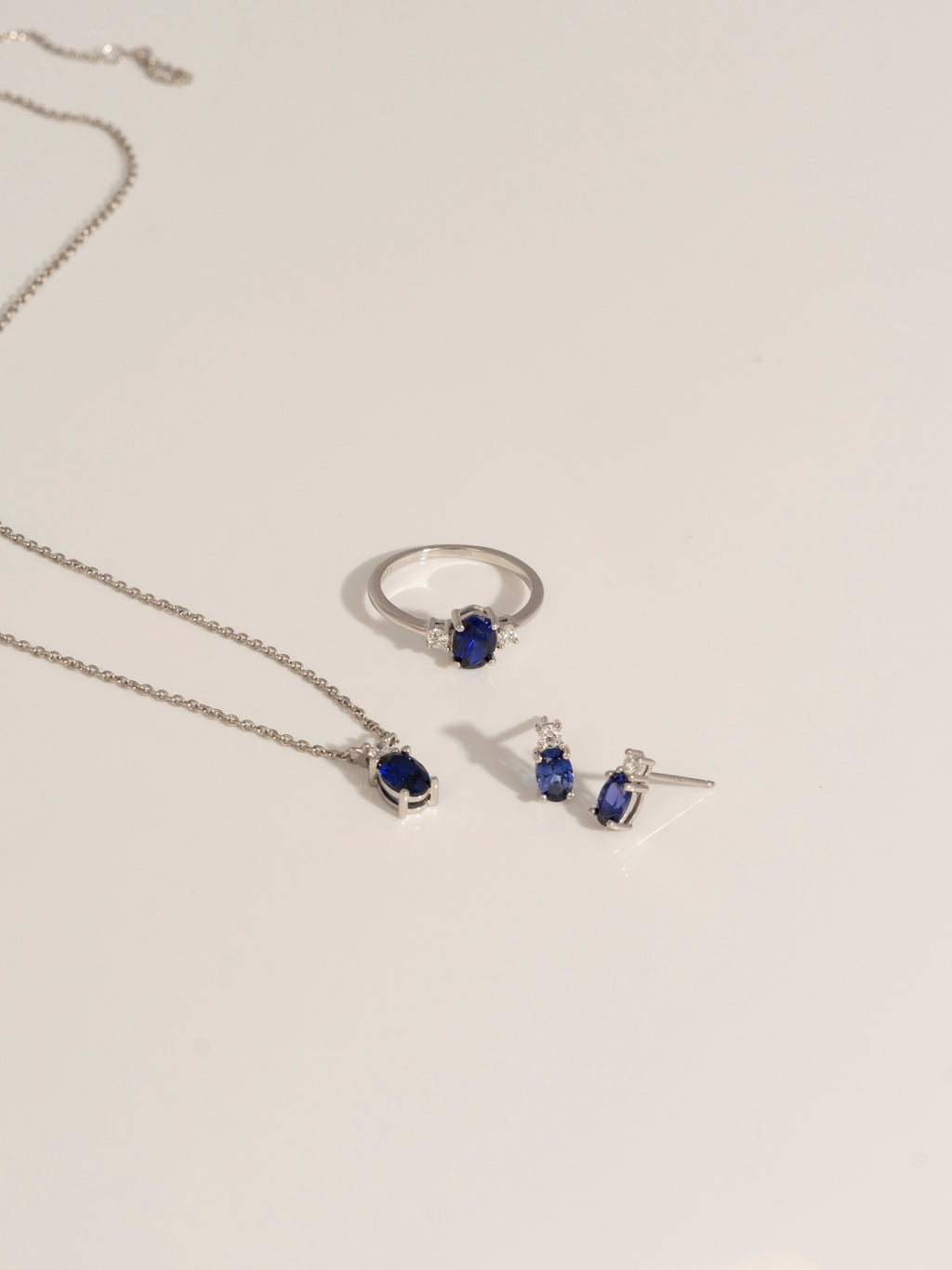 Oval Cut Created Sapphire And Lab Grown Diamond Three Stones Ring