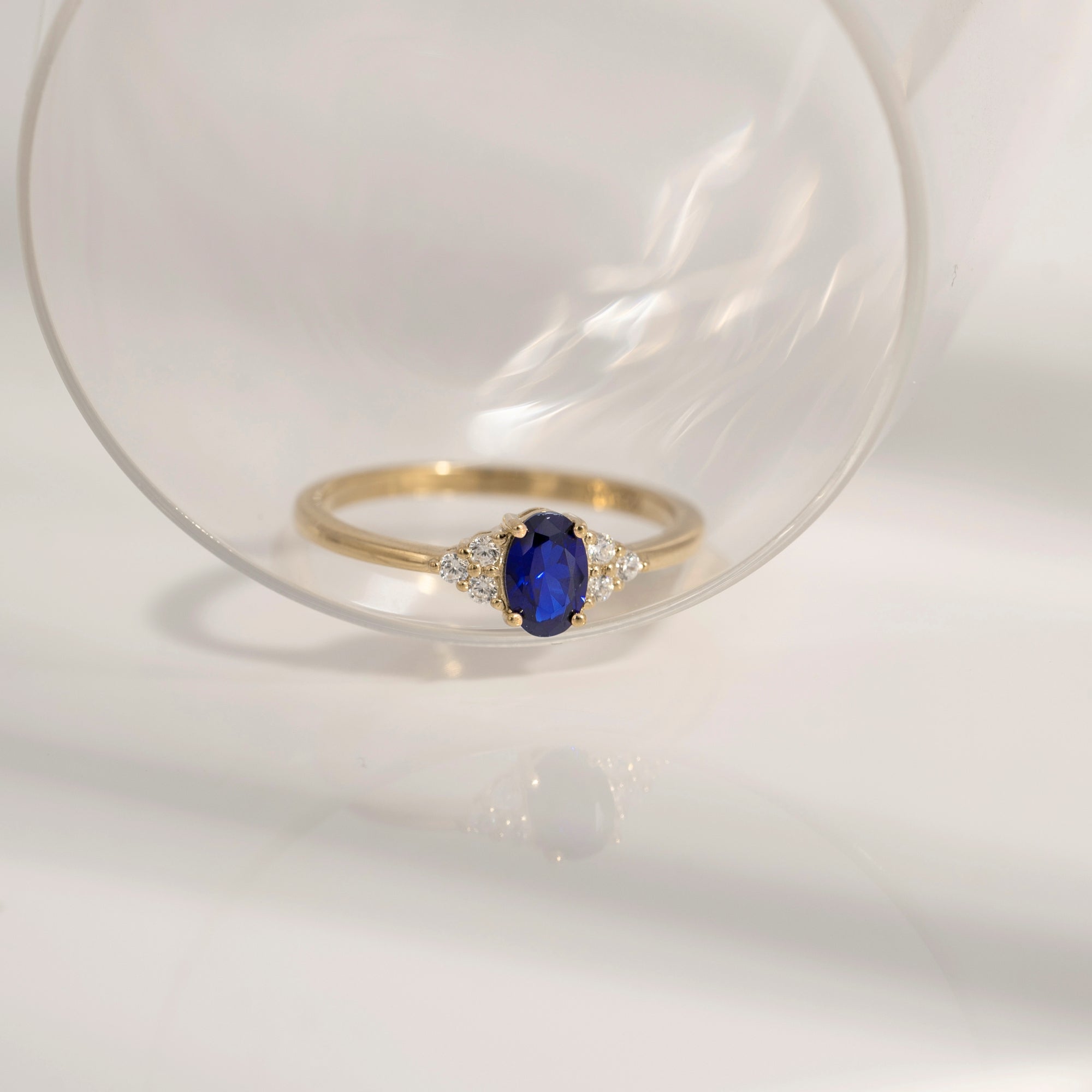 Oval Cut Sapphire With Trio Lab Grown Diamond On Shank Engagement Ring